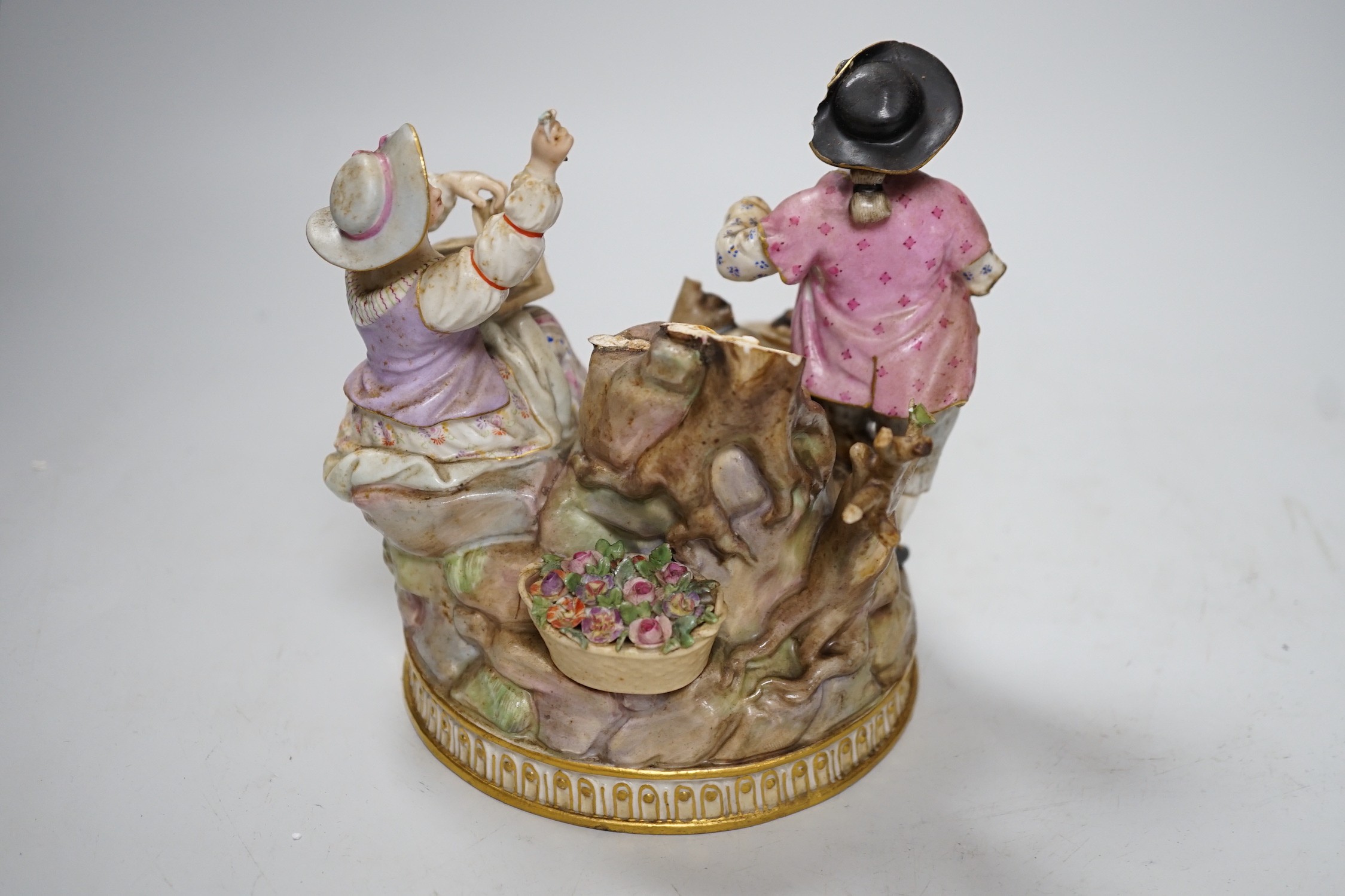 A Meissen group of flower pickers with bird cage, model F94 (a.f.)